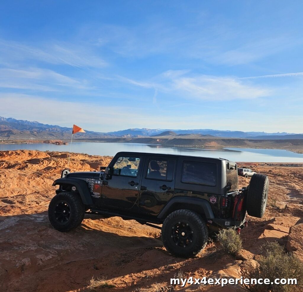 Black Jeep Wrangler parked on Sand Mountain overlooking Sand Hollow Reservoir during Matt’s Off Road Games at Sand Hollow State Park in Utah.