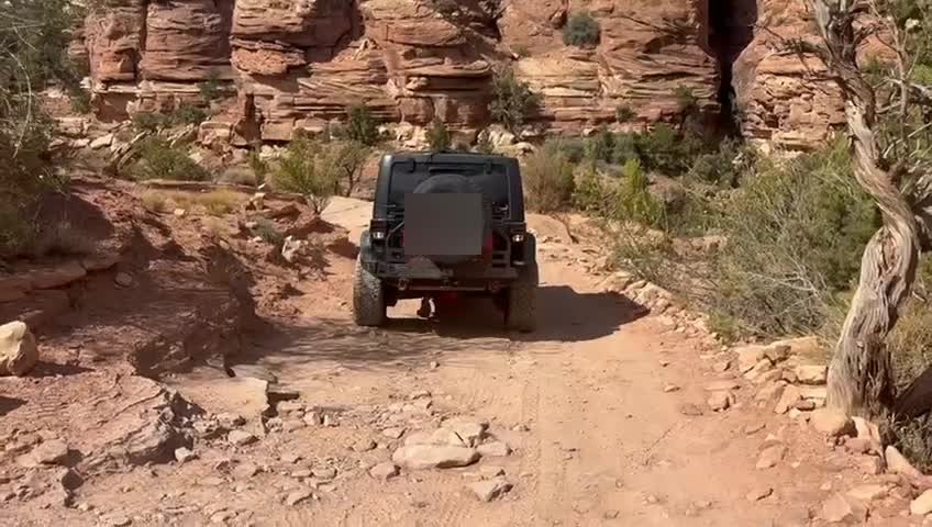 Jeep backing up a tight switchback on Elephant Hill