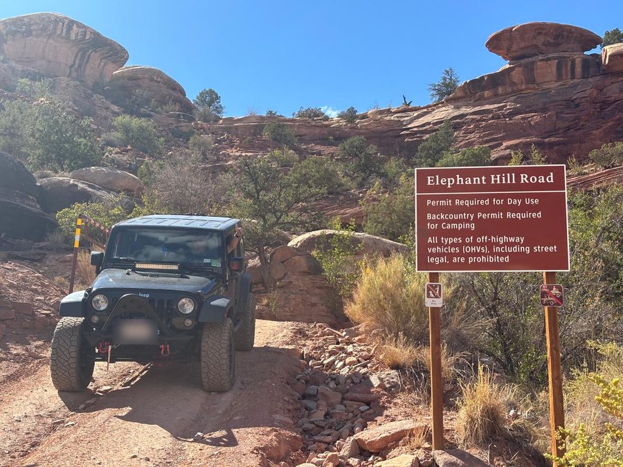 Elephant Hill Jeep trail sign listing permit requirements at the start of the 4WD road